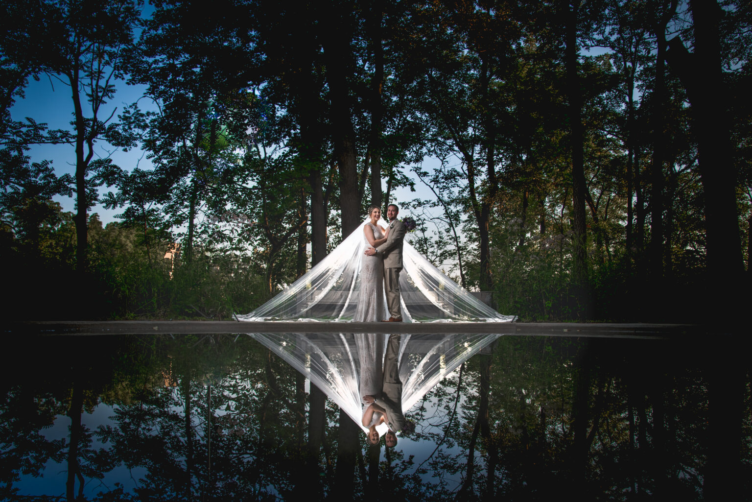 Couple in front of water during their wedding.