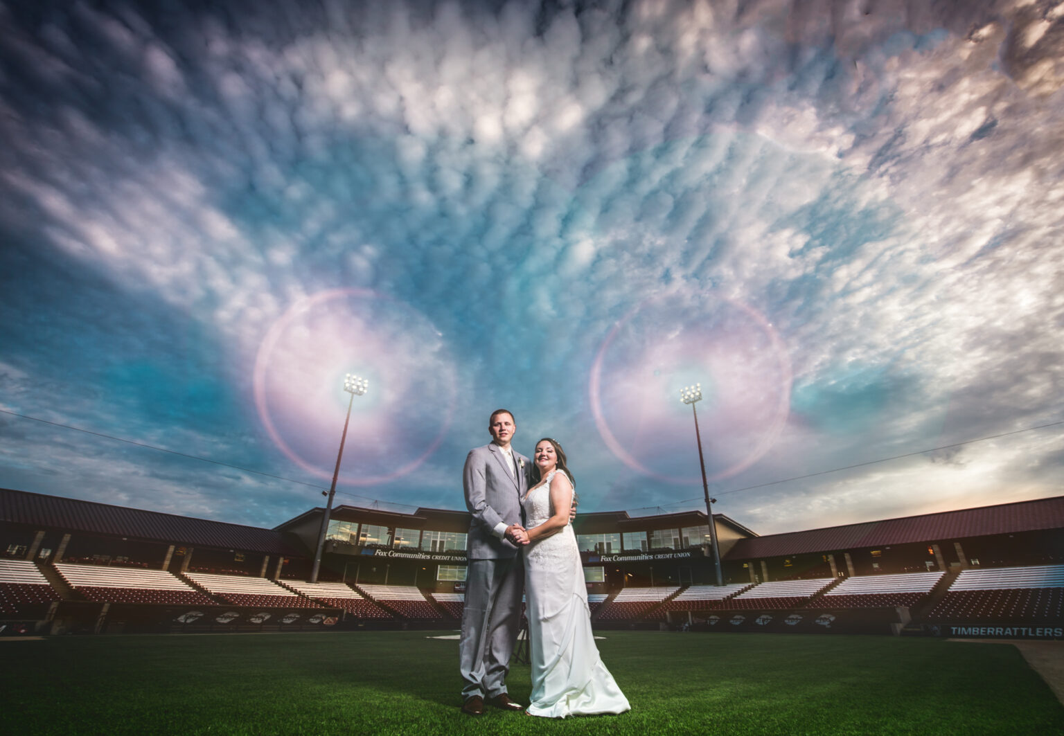 Couple in a stadium for their wedding portraits in Wisconsin.
