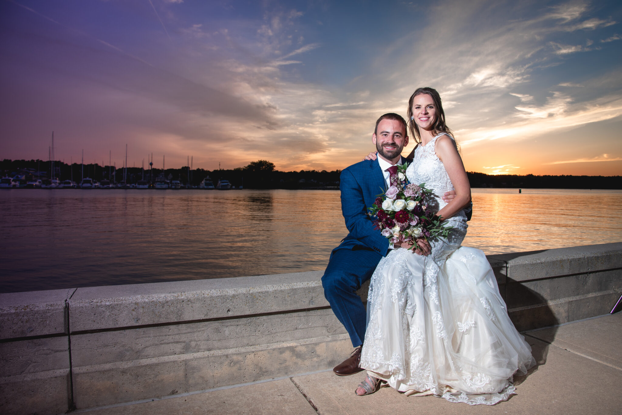 door county couple getting married with a sunset and green bay behind them