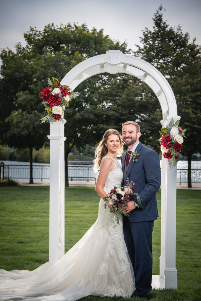 A couple under the wedding archway in door county