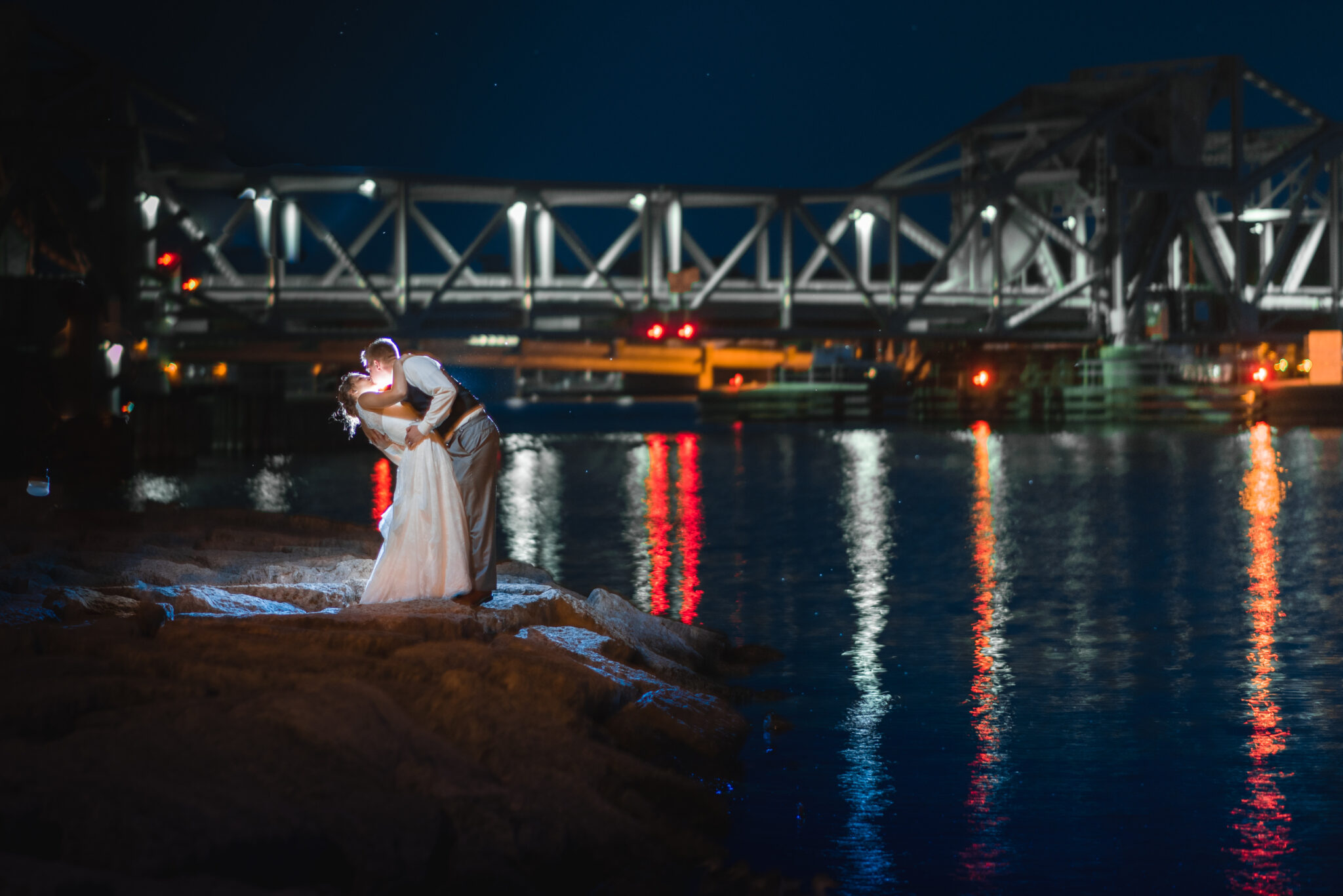 Couple kissing at night time on their wedding night on the water in door county