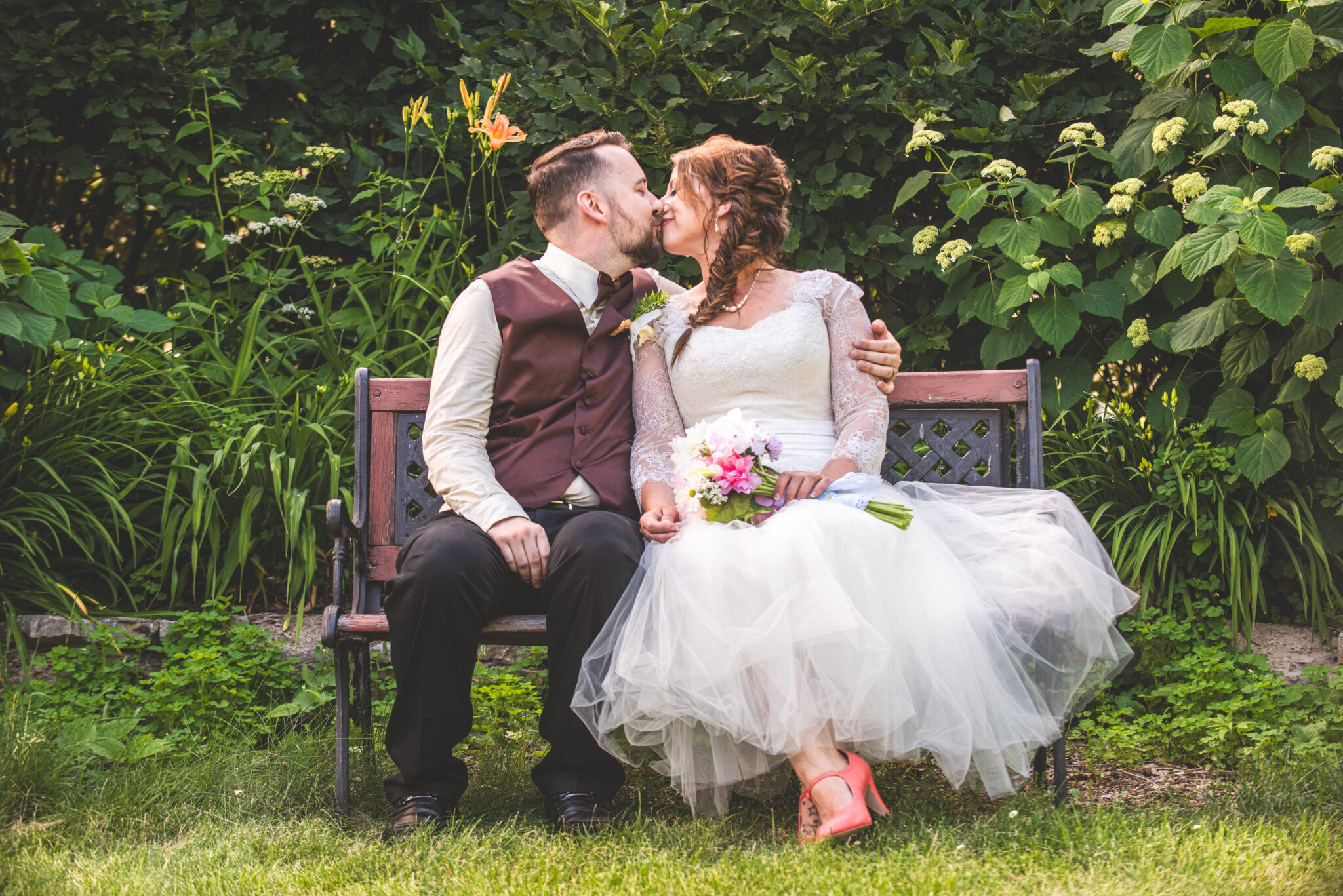 a couple on their wedding day at high cliff state park kissing