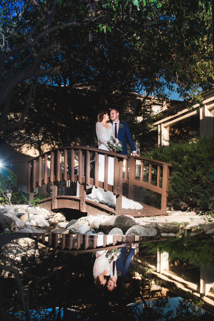 Coulpe on a bridge in lake geneva wisconsin on their wedding day