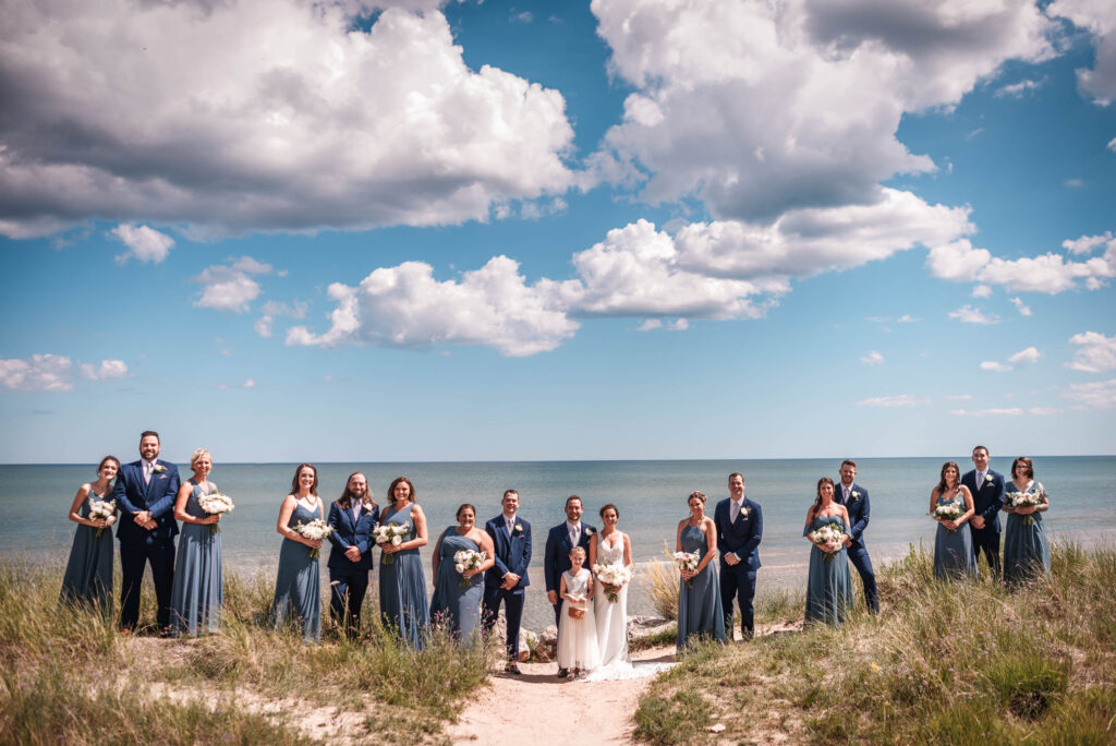 Greater wisconsin area wedding party on a beach on lake michigan