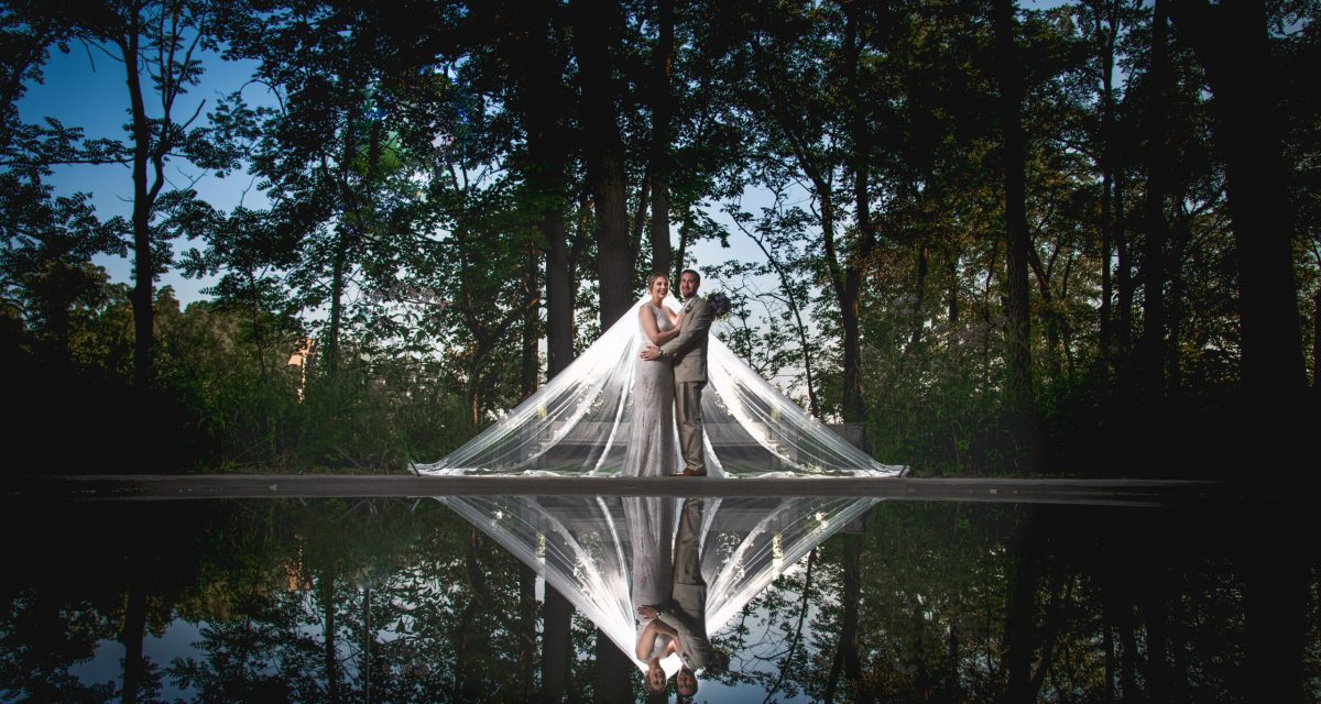Couple in front of water during their wedding.