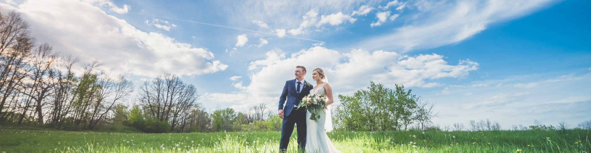 A couple in a field in Wisconsin on their wedding day.